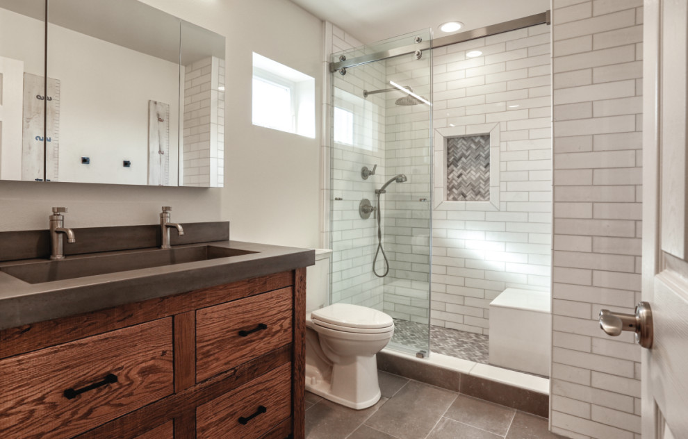 Small contemporary kids bathroom in Orange County with furniture-like cabinets, distressed cabinets, an alcove shower, a two-piece toilet, white tile, marble, porcelain floors, an integrated sink, concrete benchtops, grey floor, a sliding shower screen, grey benchtops, a niche, a double vanity, a built-in vanity and white walls.