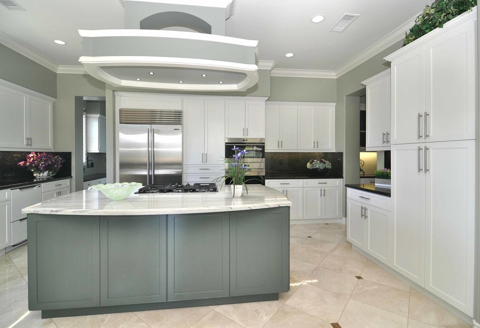 Large traditional eat-in kitchen in Los Angeles with shaker cabinets, white cabinets, marble floors and with island.