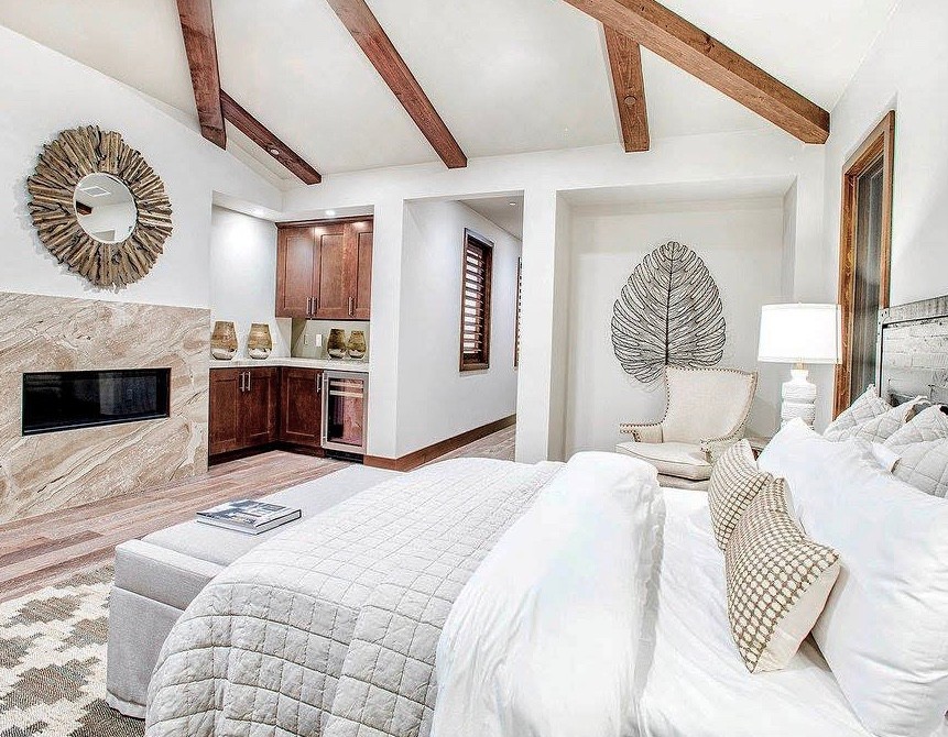 Design ideas for a large transitional master bedroom in San Diego with white walls, medium hardwood floors, a ribbon fireplace, a tile fireplace surround and brown floor.