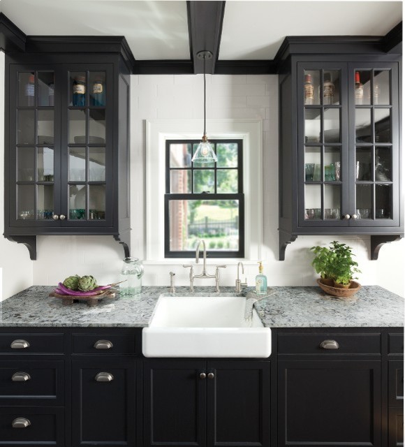 This is an example of a mid-sized contemporary eat-in kitchen in New York with beaded inset cabinets, black cabinets, stainless steel appliances, with island, a farmhouse sink, granite benchtops, white splashback and subway tile splashback.