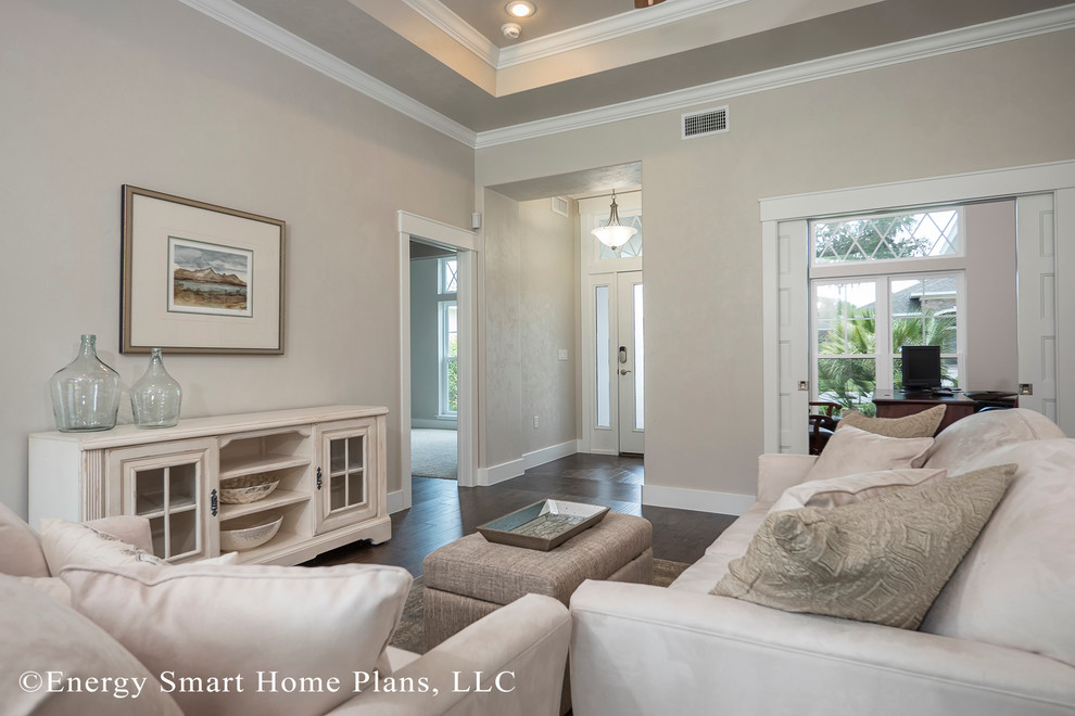 This is an example of a small arts and crafts open concept living room in Orlando with beige walls, medium hardwood floors and a wall-mounted tv.