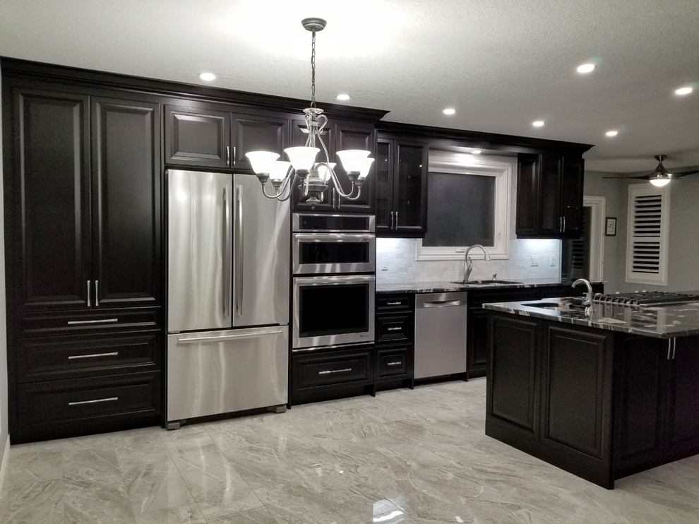 Inspiration for a modern galley gray floor eat-in kitchen remodel in Toronto with an undermount sink, raised-panel cabinets, dark wood cabinets, gray backsplash, stainless steel appliances, an island and multicolored countertops