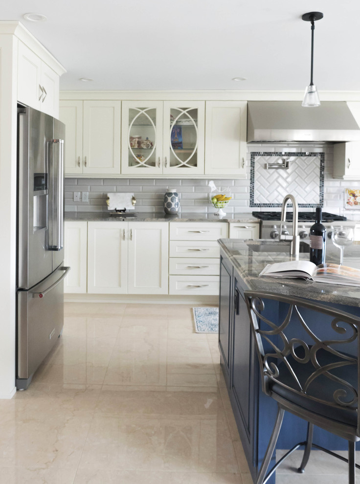 Design ideas for a large transitional u-shaped eat-in kitchen in Other with a farmhouse sink, glass-front cabinets, blue cabinets, granite benchtops, grey splashback, subway tile splashback, stainless steel appliances, ceramic floors, with island, beige floor and brown benchtop.