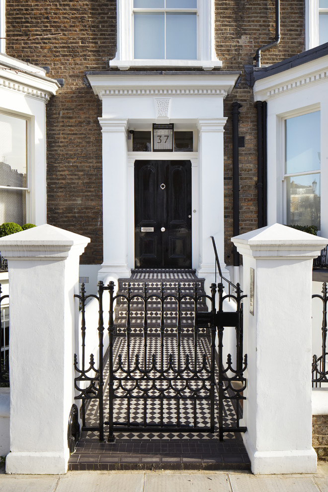 Traditional front door in London with ceramic floors, a single front door and a black front door.