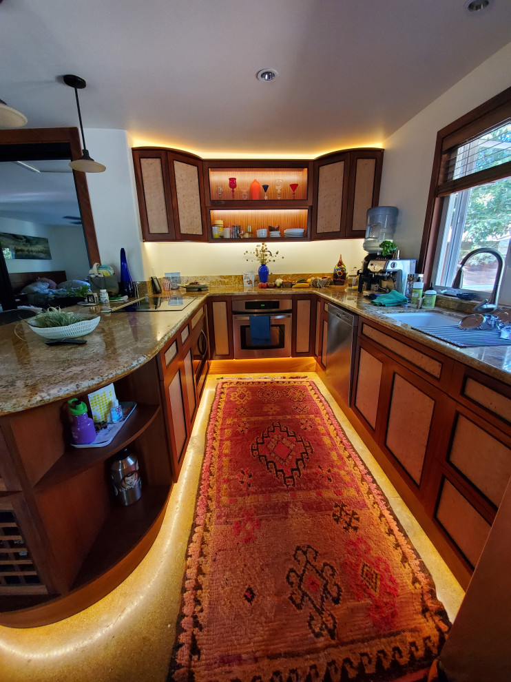 This is an example of a small u-shaped separate kitchen in Los Angeles with a single-bowl sink, recessed-panel cabinets, red cabinets, granite benchtops, beige splashback, granite splashback, stainless steel appliances, concrete floors, a peninsula, grey floor and beige benchtop.