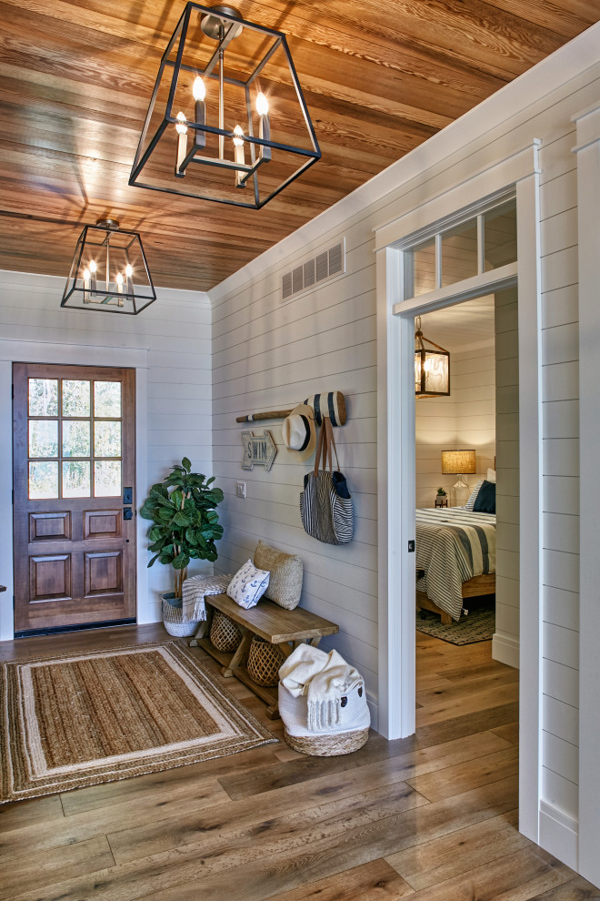 Mid-sized beach style foyer in Other with white walls, light hardwood floors, a single front door, a brown front door and multi-coloured floor.