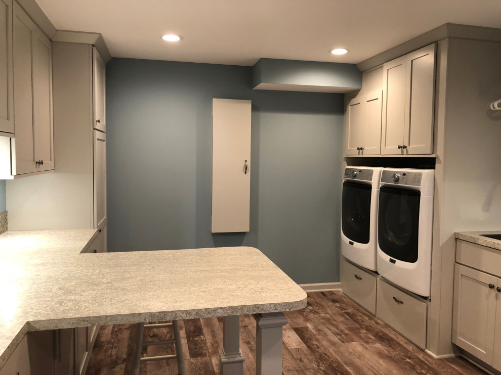 Large laundry room in Grand Rapids with shaker cabinets, grey cabinets and laminate benchtops.