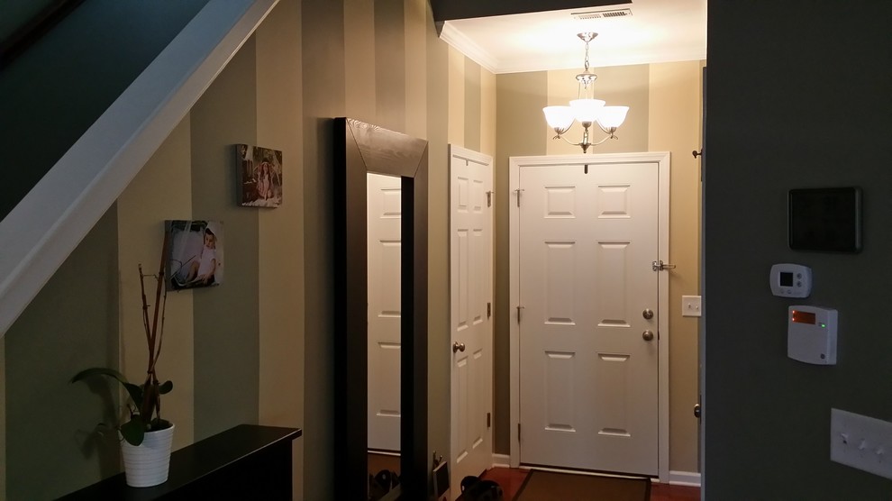 Mid-sized transitional dark wood floor and brown floor foyer photo in Albuquerque with multicolored walls and a white front door