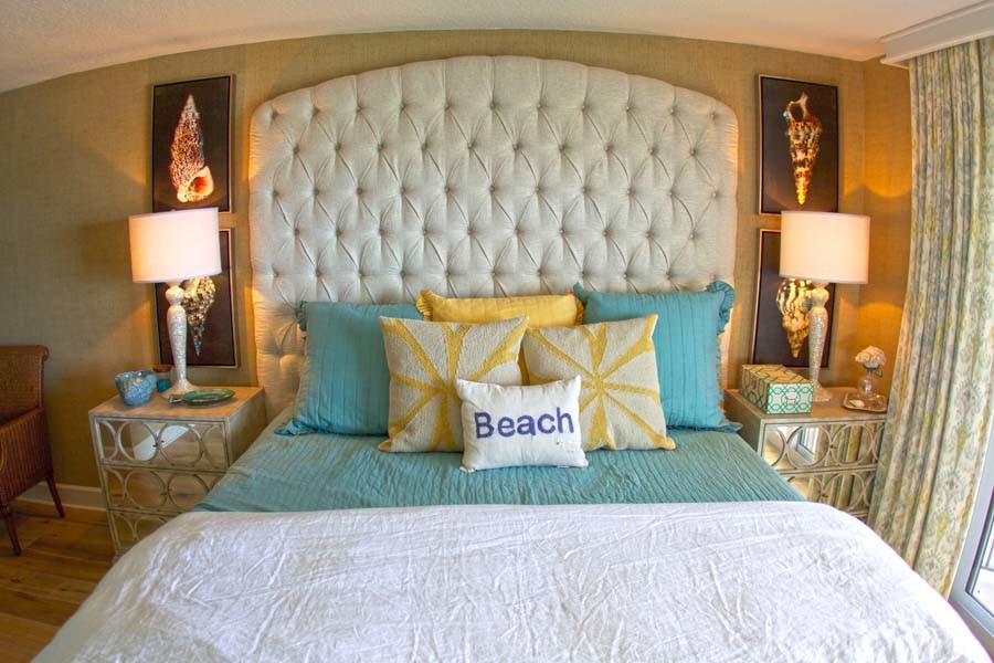 Mid-sized beach style master bedroom in Orlando with beige walls and light hardwood floors.