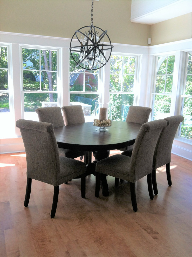 Photo of a mid-sized transitional dining room in Providence with medium hardwood floors and red floor.