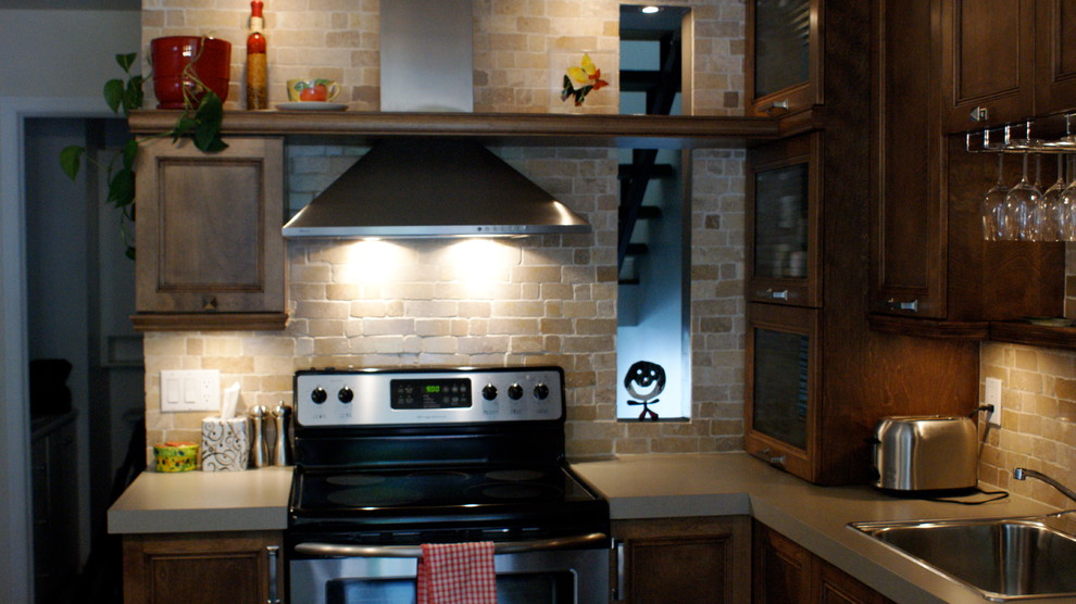 Example of a small transitional eat-in kitchen design with a drop-in sink, shaker cabinets, brown cabinets, laminate countertops, multicolored backsplash, stone slab backsplash, stainless steel appliances and an island