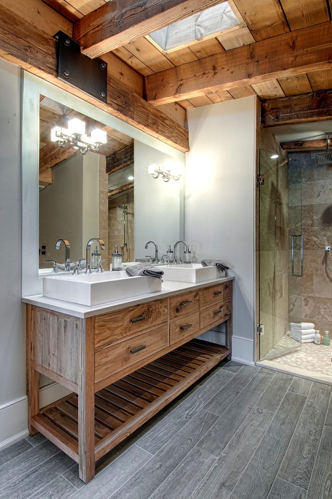 Design ideas for a country master bathroom in Toronto with furniture-like cabinets, engineered quartz benchtops, a curbless shower, gray tile, stone tile, ceramic floors and medium wood cabinets.