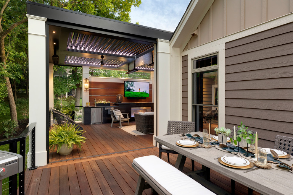 Design ideas for a mid-sized contemporary backyard deck in Minneapolis with with privacy feature and a pergola.