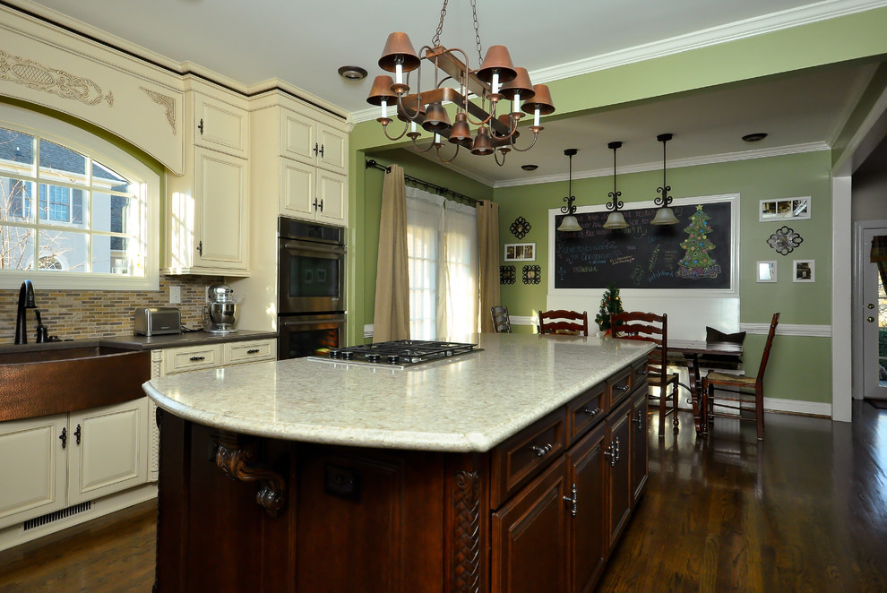 Mid-sized transitional l-shaped dark wood floor eat-in kitchen photo with a farmhouse sink, raised-panel cabinets, white cabinets, granite countertops, multicolored backsplash, mosaic tile backsplash, stainless steel appliances and an island