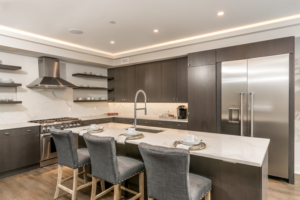 Design ideas for a contemporary l-shaped kitchen in DC Metro with an undermount sink, flat-panel cabinets, dark wood cabinets, white splashback, stainless steel appliances, light hardwood floors, with island and beige floor.