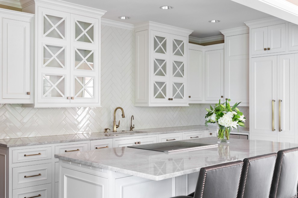 Inspiration for a large transitional l-shaped open plan kitchen in Kansas City with an undermount sink, recessed-panel cabinets, white cabinets, white splashback, subway tile splashback, with island, quartzite benchtops, panelled appliances, medium hardwood floors and white benchtop.