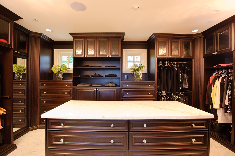 Inspiration for a traditional dressing room in Vancouver with dark wood cabinets.