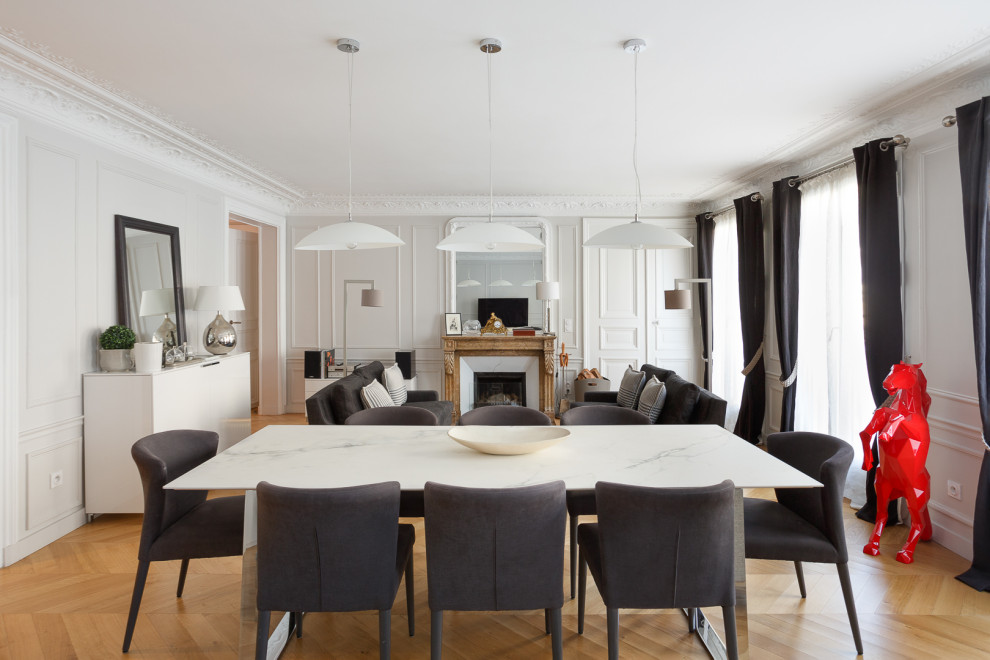 Exemple d'une salle à manger ouverte sur le salon tendance de taille moyenne avec un mur blanc, parquet clair, aucune cheminée et un sol beige.