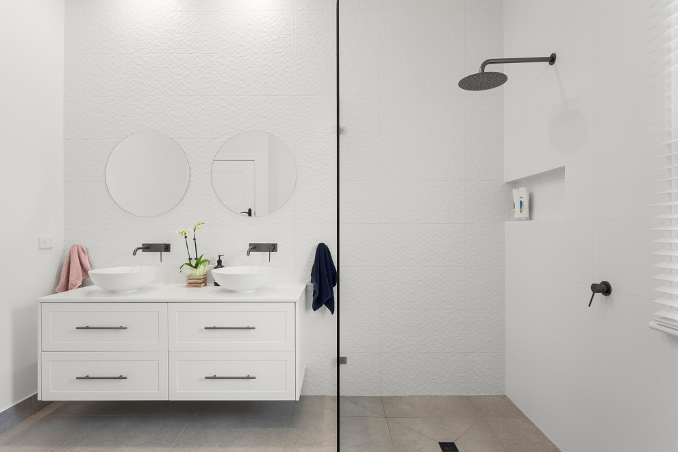 Design ideas for a mid-sized contemporary kids bathroom in Melbourne with shaker cabinets, white cabinets, an open shower, white tile, ceramic tile, white walls, ceramic floors, engineered quartz benchtops, grey floor, an open shower, white benchtops, a niche, a double vanity and a floating vanity.