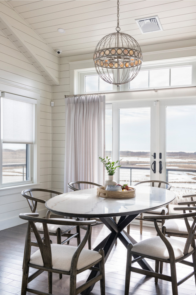Beach style open plan dining in Providence with white walls, medium hardwood floors, no fireplace, brown floor, timber, vaulted and planked wall panelling.