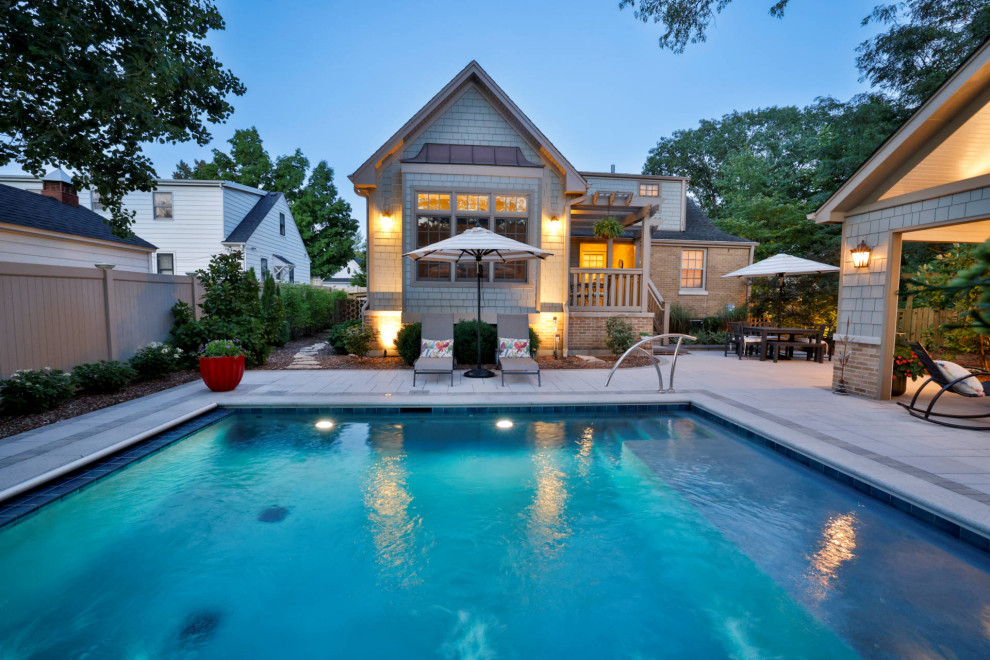 Pool house - small traditional backyard stone and rectangular pool house idea in Chicago