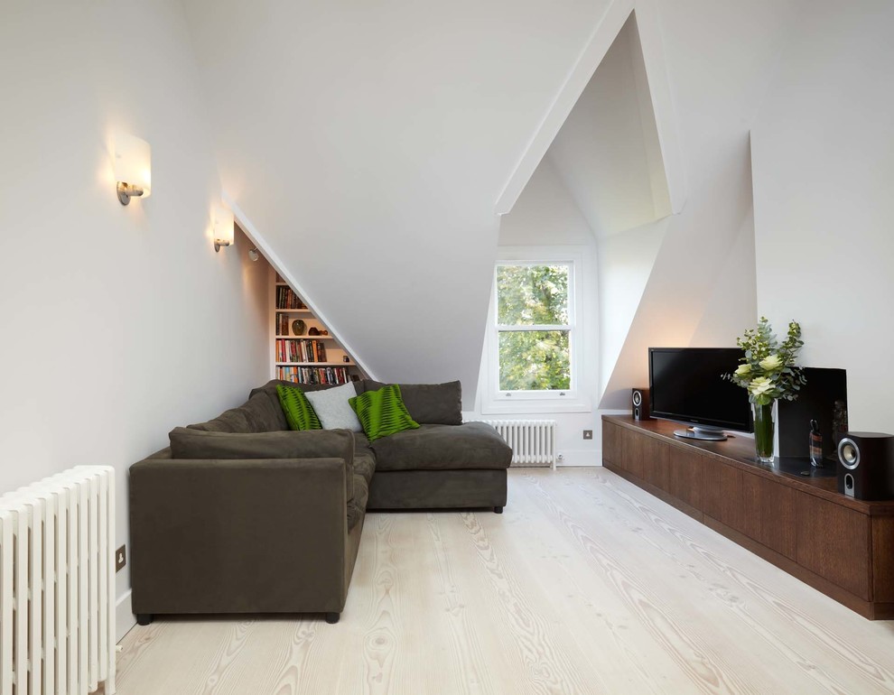Design ideas for a mid-sized scandinavian formal open concept living room in London with white walls, light hardwood floors and a freestanding tv.
