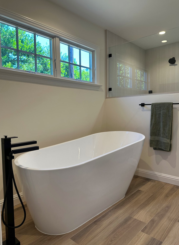 Large modern master bathroom in San Francisco with white cabinets, a freestanding tub, an alcove shower, beige tile, ceramic tile, beige walls, wood-look tile, brown floor, a hinged shower door, beige benchtops, a niche and a double vanity.