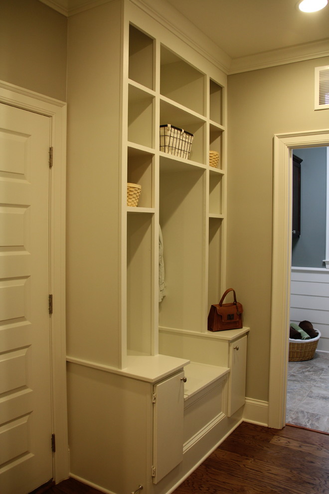 Design ideas for a country mudroom in Raleigh with grey walls, medium hardwood floors, a double front door, a medium wood front door and brown floor.