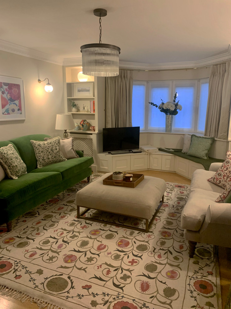 This is an example of a medium sized classic formal living room in London with medium hardwood flooring and brown floors.