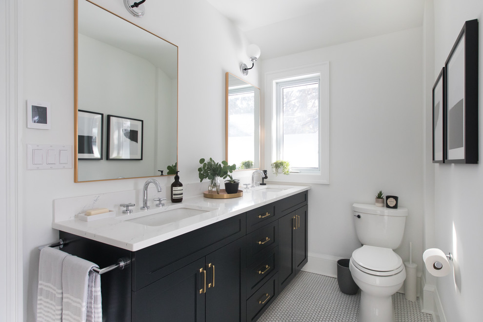 This is an example of a mid-sized transitional master bathroom in Toronto with recessed-panel cabinets, black cabinets, a two-piece toilet, white walls, mosaic tile floors, an undermount sink, quartzite benchtops, white floor and white benchtops.