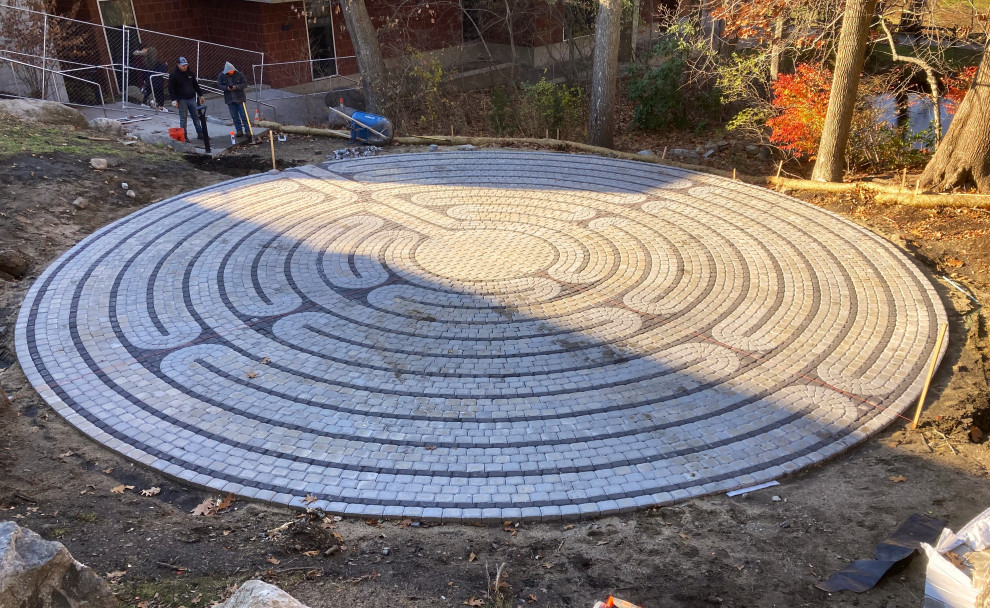 Photo of a large transitional courtyard patio in Providence with concrete pavers.