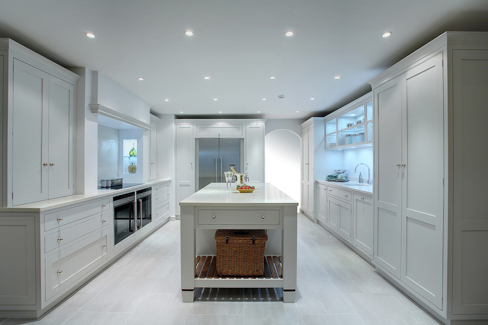Design ideas for a transitional u-shaped kitchen in Gloucestershire with an undermount sink, shaker cabinets, grey cabinets, stainless steel appliances and with island.