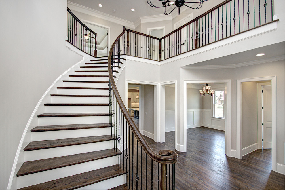 This is an example of an expansive transitional foyer in Charlotte with grey walls and medium hardwood floors.