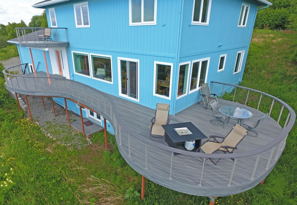 Example of a large side yard ground level cable railing deck design with no cover