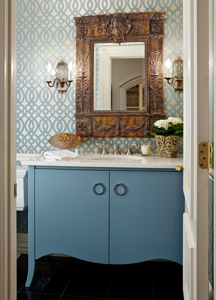 This is an example of a small beach style bathroom in Dallas with flat-panel cabinets, blue cabinets, a two-piece toilet, blue walls, dark hardwood floors, an undermount sink and marble benchtops.