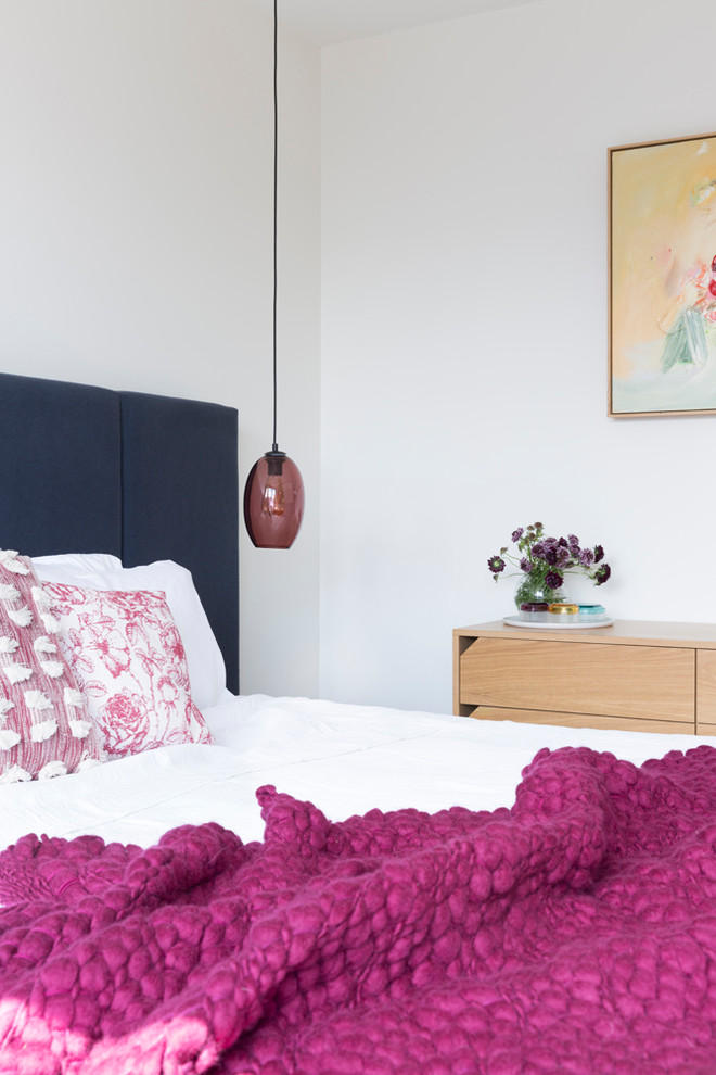 This is an example of a mid-sized contemporary master bedroom in Melbourne with white walls.