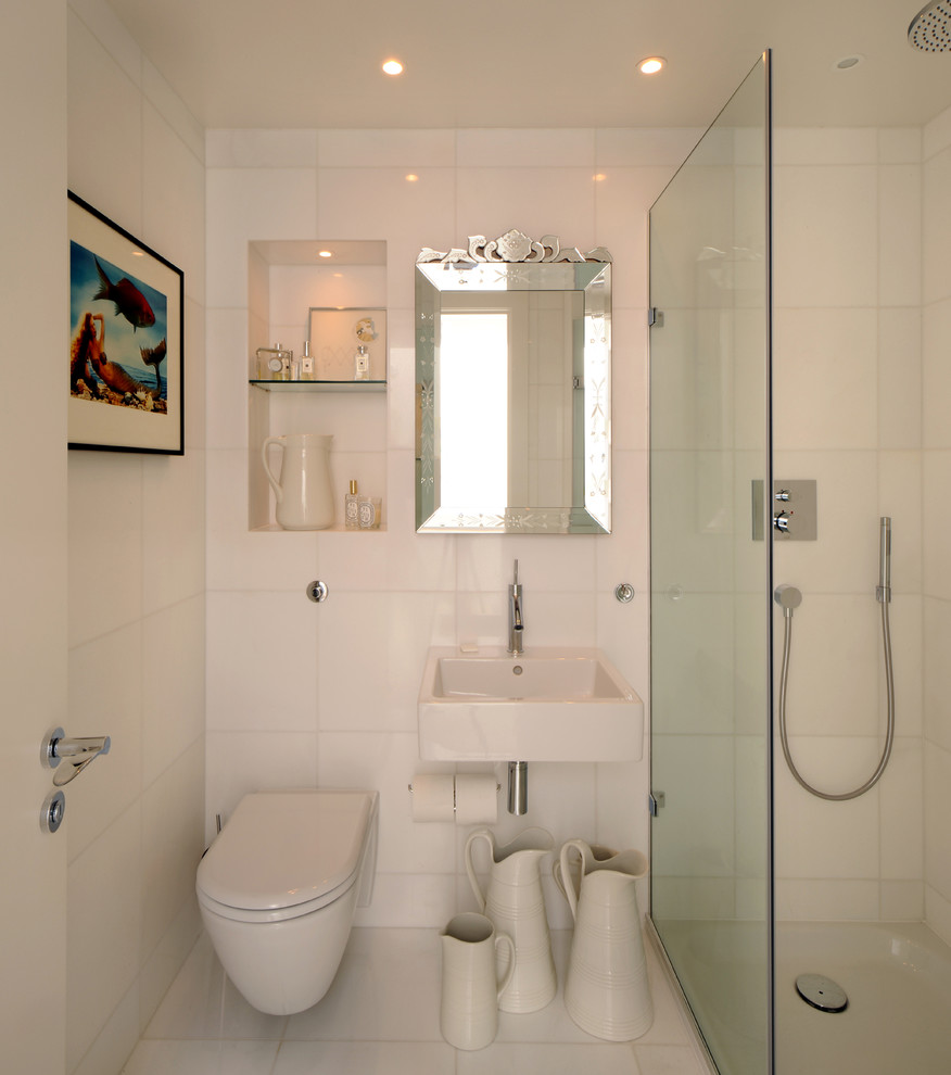 Photo of a small scandinavian shower room bathroom in London with a wall-mounted sink, a built-in shower, a wall mounted toilet, white tiles, ceramic tiles, ceramic flooring and white walls.