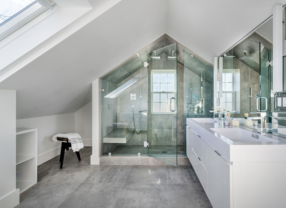 Inspiration for a mid-sized contemporary master bathroom in Boston with flat-panel cabinets, white cabinets, a double shower, gray tile, white walls, an integrated sink, grey floor, a hinged shower door, porcelain tile and porcelain floors.