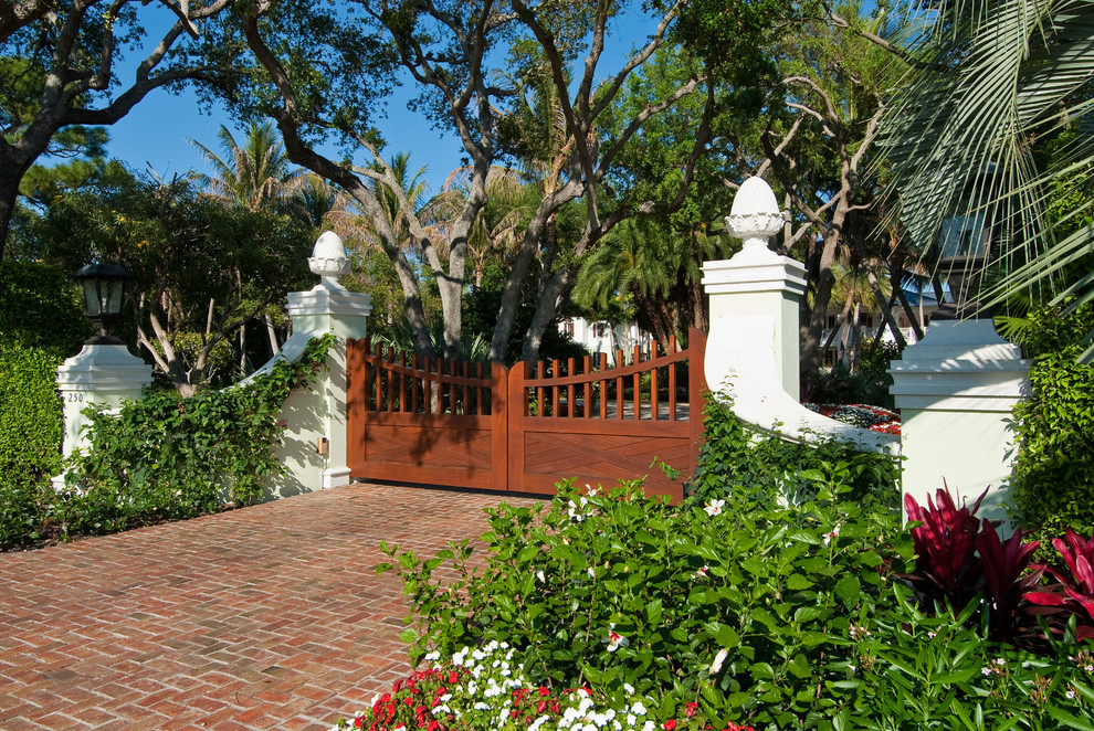 Photo of a tropical driveway in Miami with brick pavers.