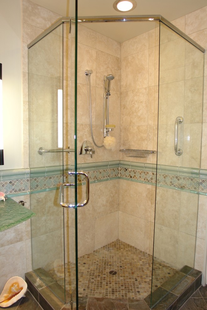 Photo of a mid-sized beach style master bathroom in San Diego with open cabinets, blue cabinets, a corner tub, a corner shower, a one-piece toilet, beige tile, blue tile, brown tile, gray tile, multi-coloured tile, white tile, mosaic tile, beige walls, porcelain floors, a pedestal sink and glass benchtops.
