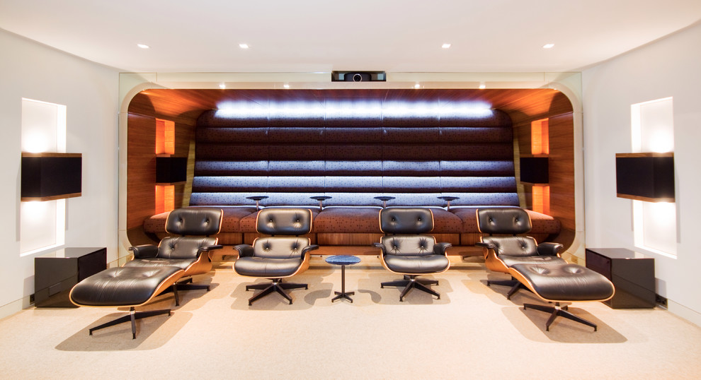 Photo of a large contemporary enclosed home theatre in Sydney with white walls, a projector screen and carpet.