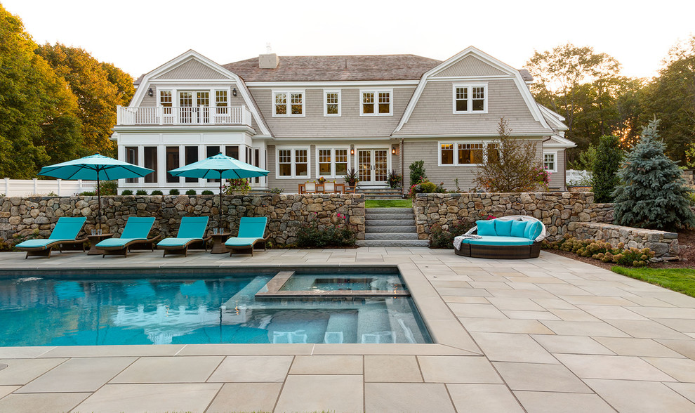 Inspiration for a traditional backyard partial sun garden in Boston with a fire feature and natural stone pavers.