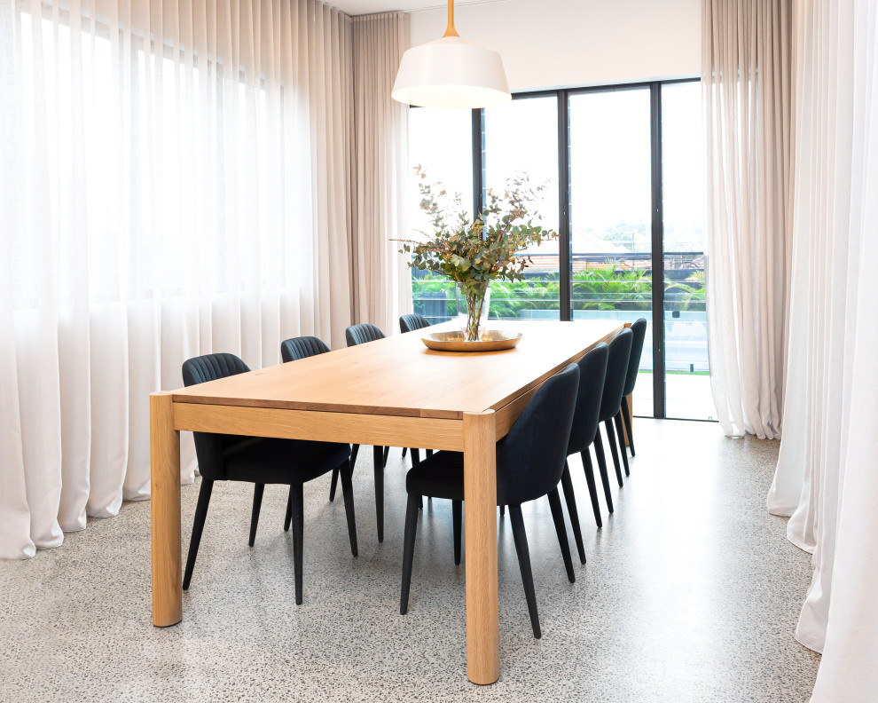 Mid-sized contemporary dining room in Sydney with white walls, concrete floors and grey floor.