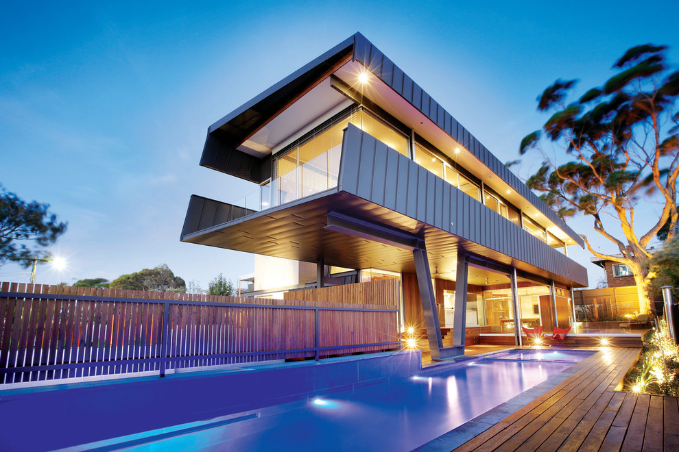 Inspiration for a mid-sized contemporary backyard rectangular lap pool in Melbourne with decking and a hot tub.