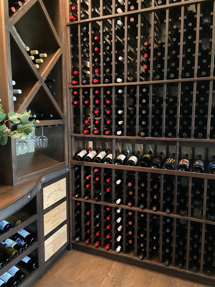 This is an example of a large classic wine cellar in San Diego with storage racks.