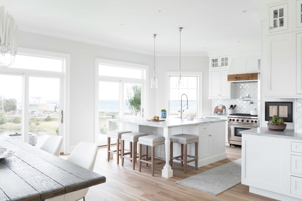 Example of a large transitional l-shaped open concept kitchen design with beaded inset cabinets, quartzite countertops and an island