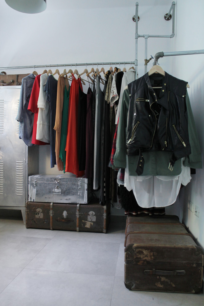 Inspiration for an industrial walk-in wardrobe in Other with open cabinets and concrete floors.