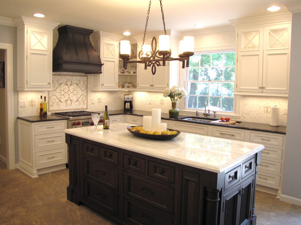 Classic l-shaped kitchen/diner in New York with beaded cabinets, white cabinets, granite worktops, orange splashback and integrated appliances.