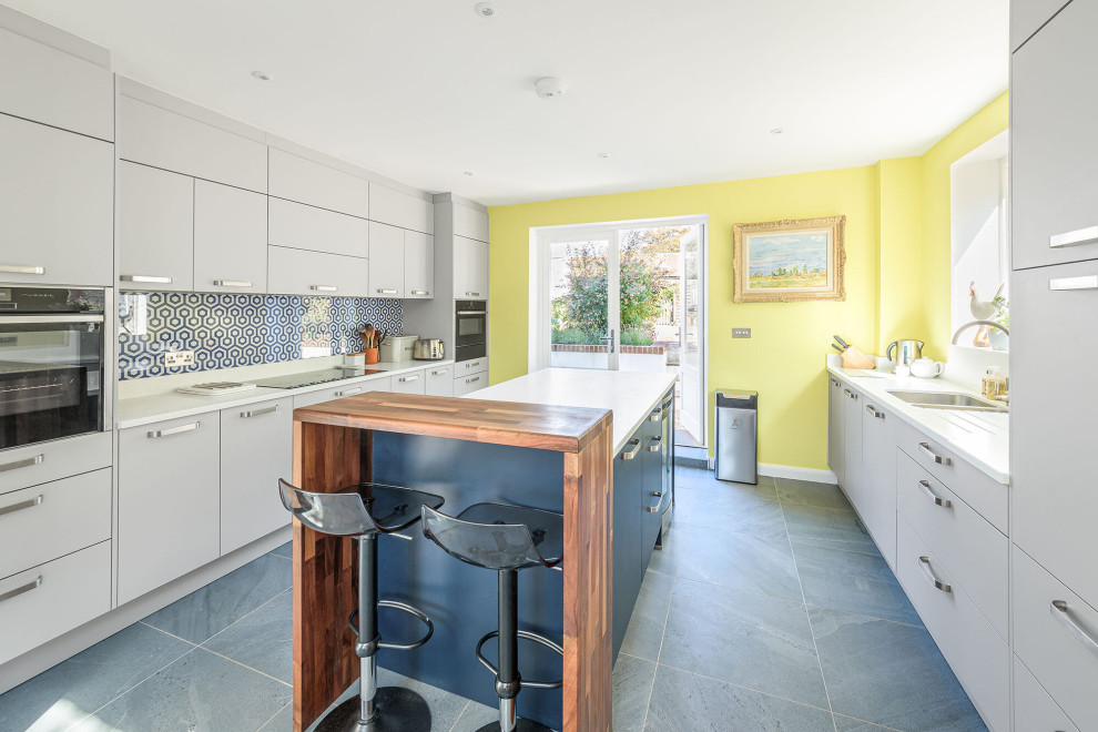 Geschlossene, Kleine Moderne Küche in U-Form mit flächenbündigen Schrankfronten und Kücheninsel in Sussex