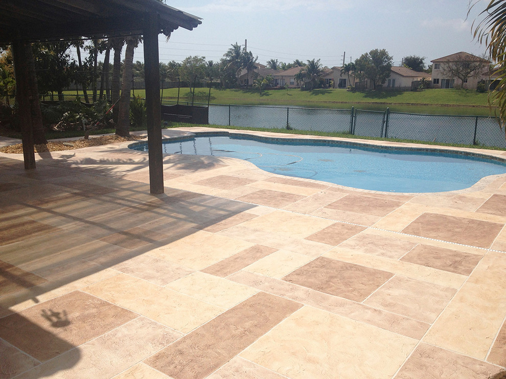 Inspiration for a large modern backyard concrete paver patio remodel in Miami
